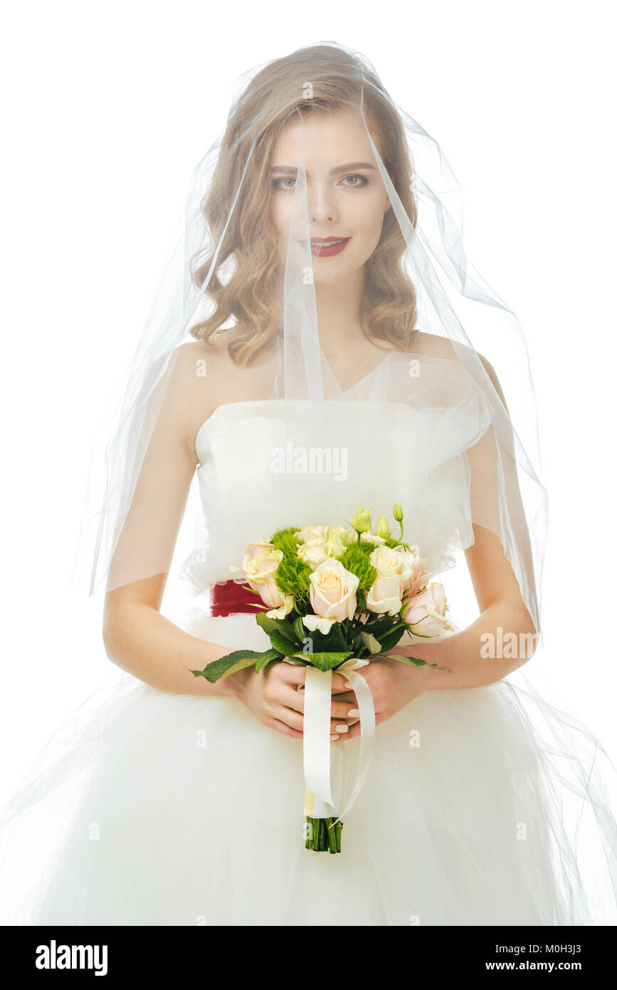 portrait of pretty bride in wedding dress and veil with wedding bouquet ...