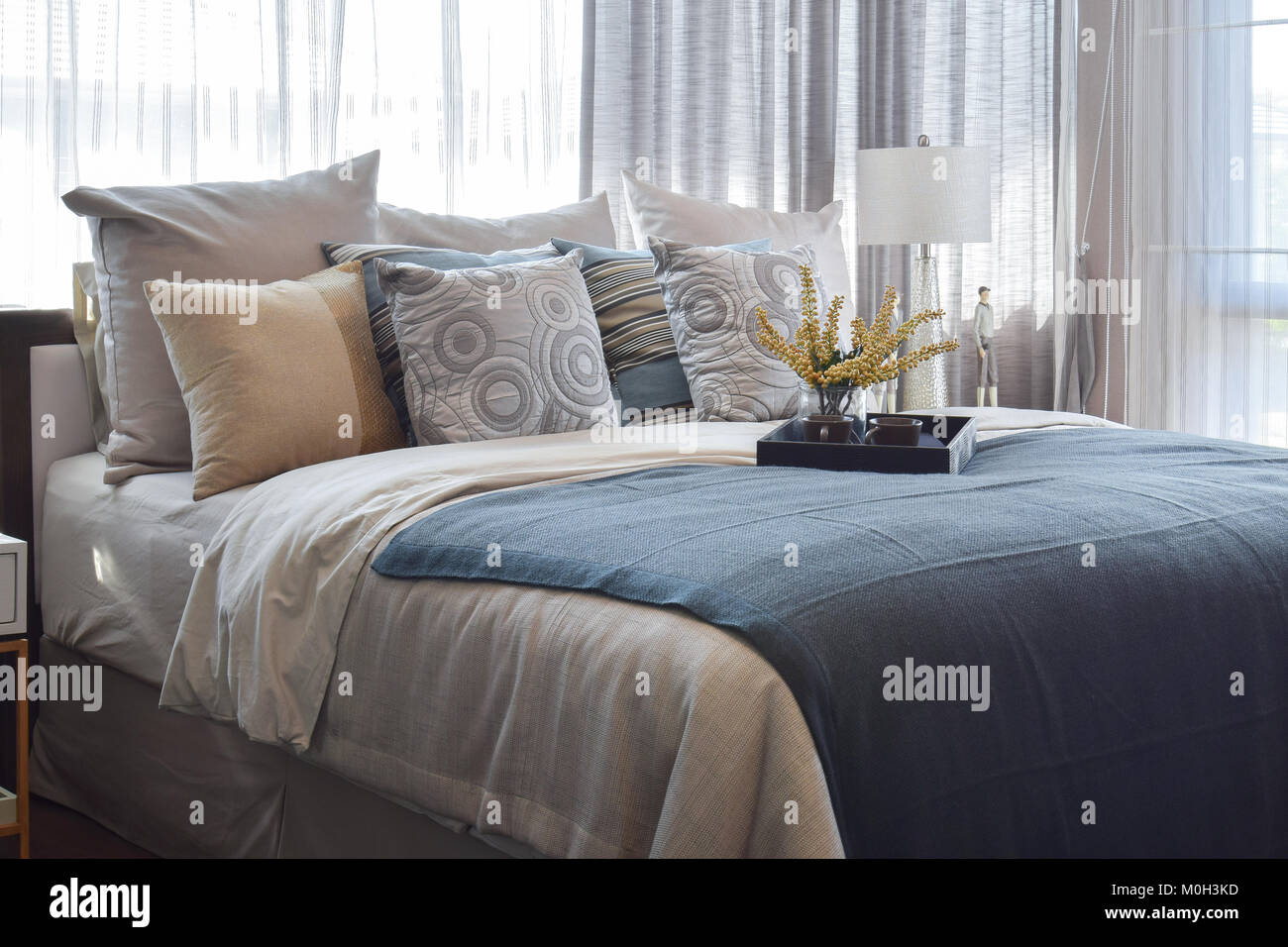 luxury bedroom interior design with striped pillows and decorative tea ...
