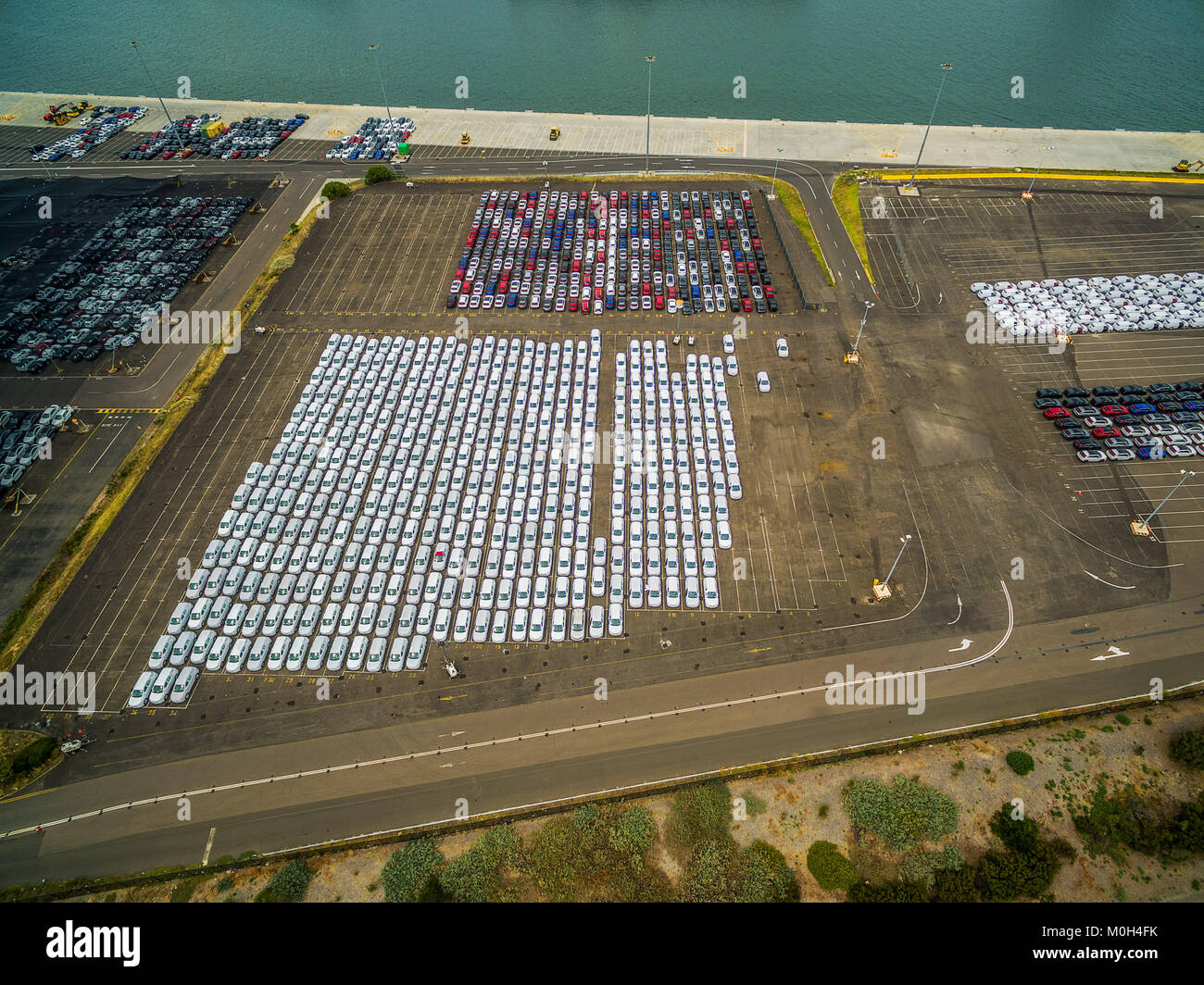 Aerial landscape of large parking lot with new imported cars in Port