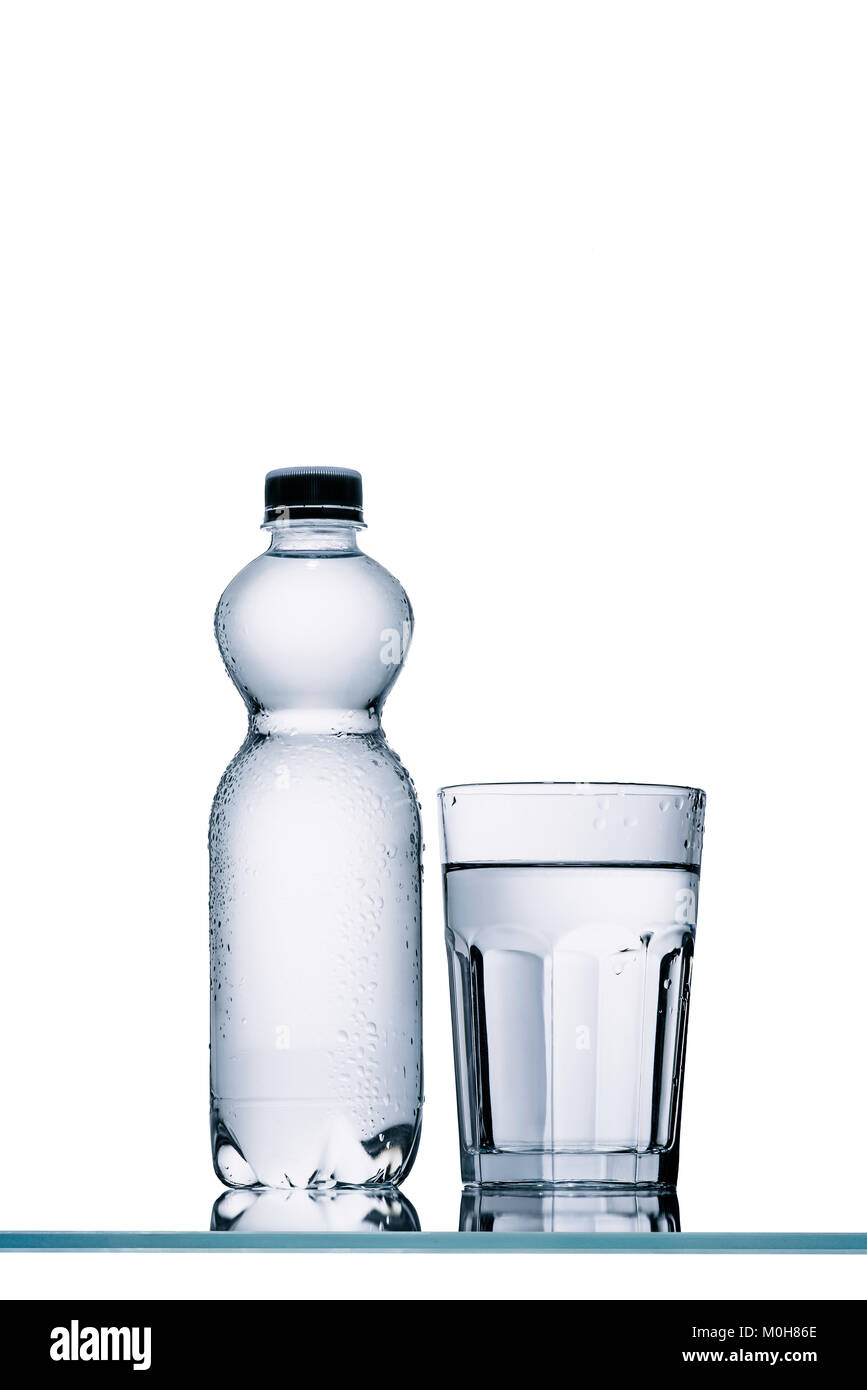 full plastic bottle of water and glass isolated on white Stock Photo