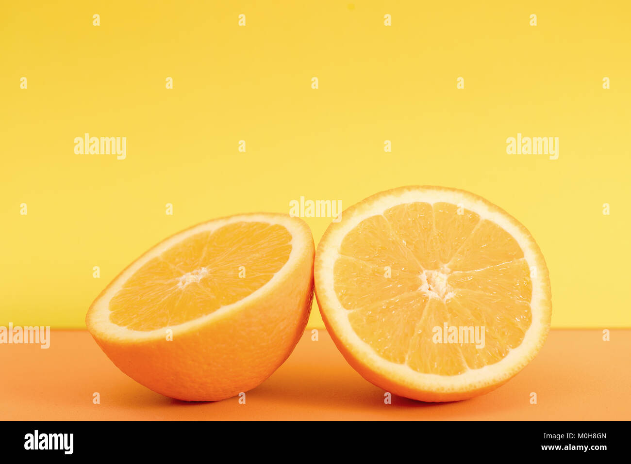Fresh orange slice isolated on orange background Stock Photo - Alamy