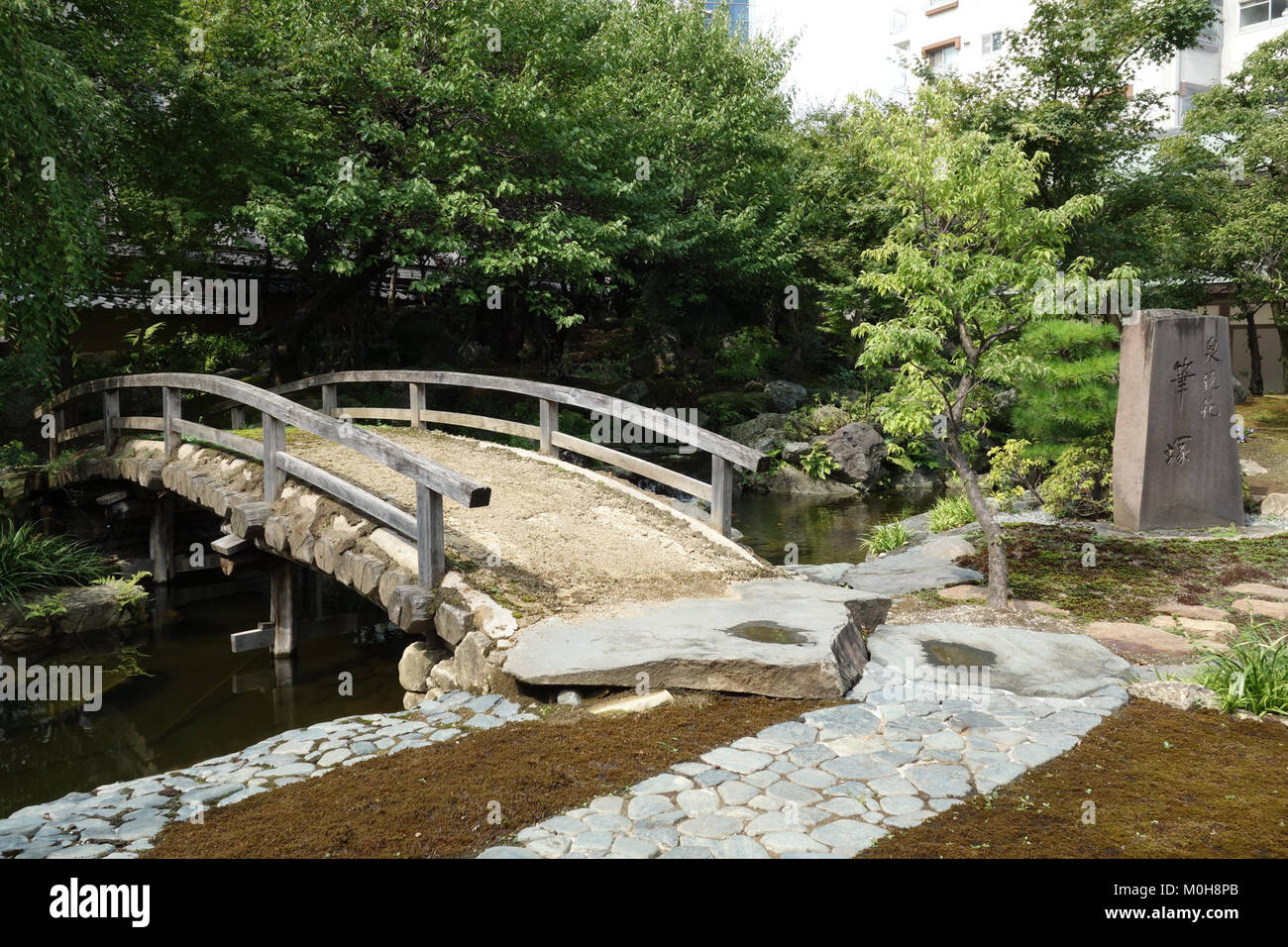 A photograph of the bridge at Yushima Tenman-gu Shrine in Tokyo, Japan, emphasizing the traditional Japanese architectural style and cultural significance. Stock Photo