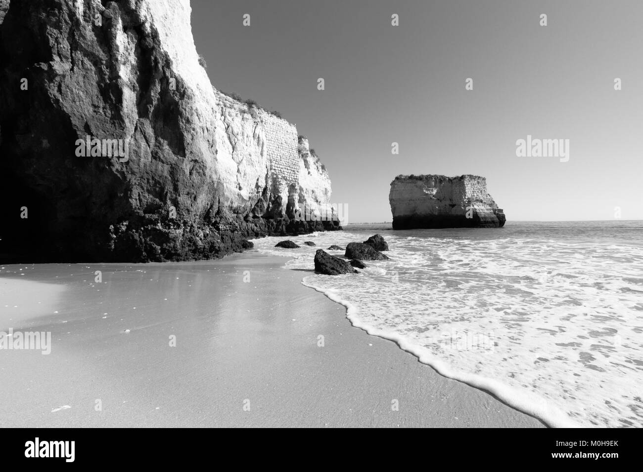 a black and white beach scene taken in Lagos, Portugal Stock Photo Alamy