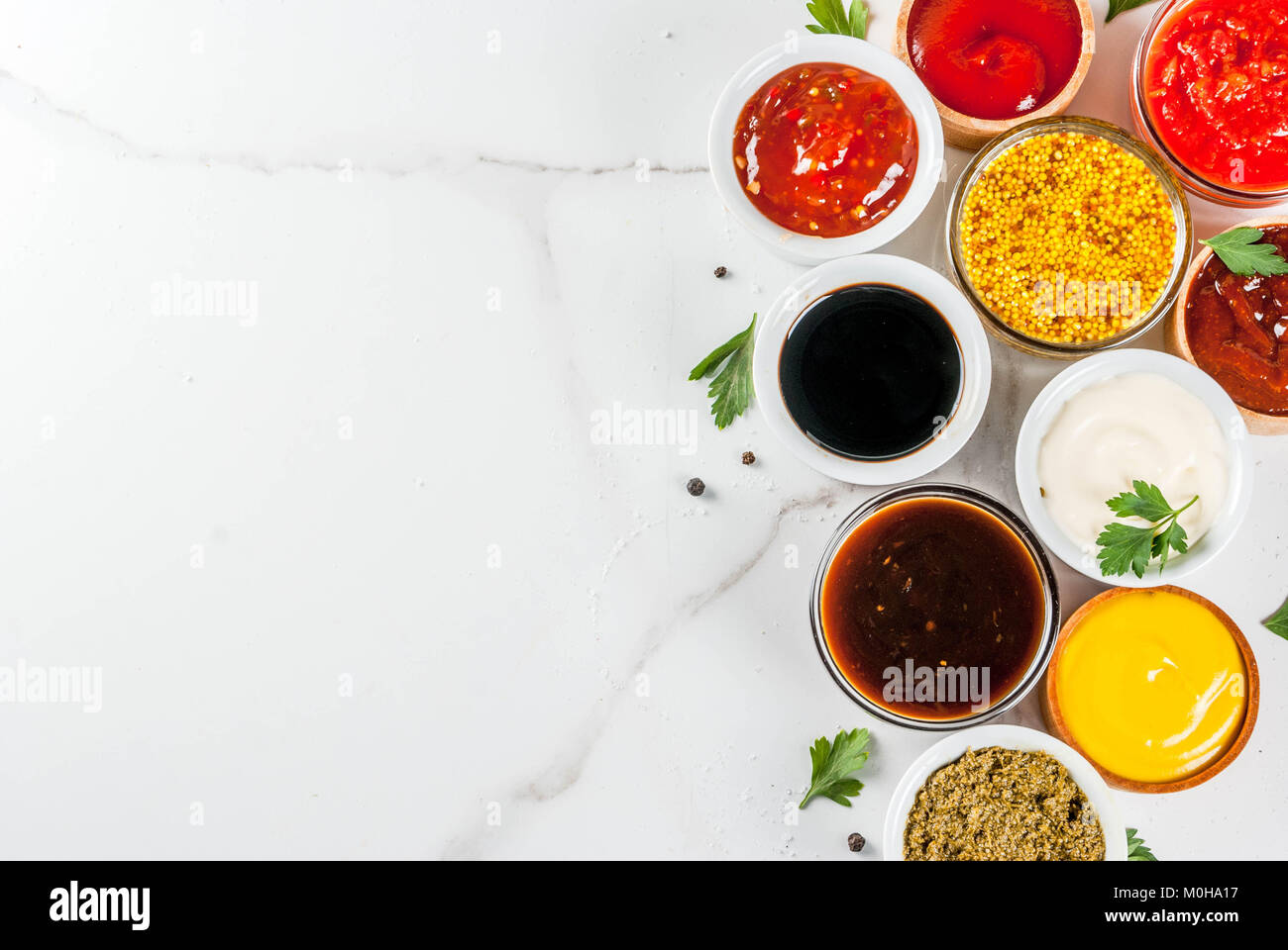 Set of different sauces ketchup, mayonnaise, barbecue, soy, teriyaki, mustard, grain hills