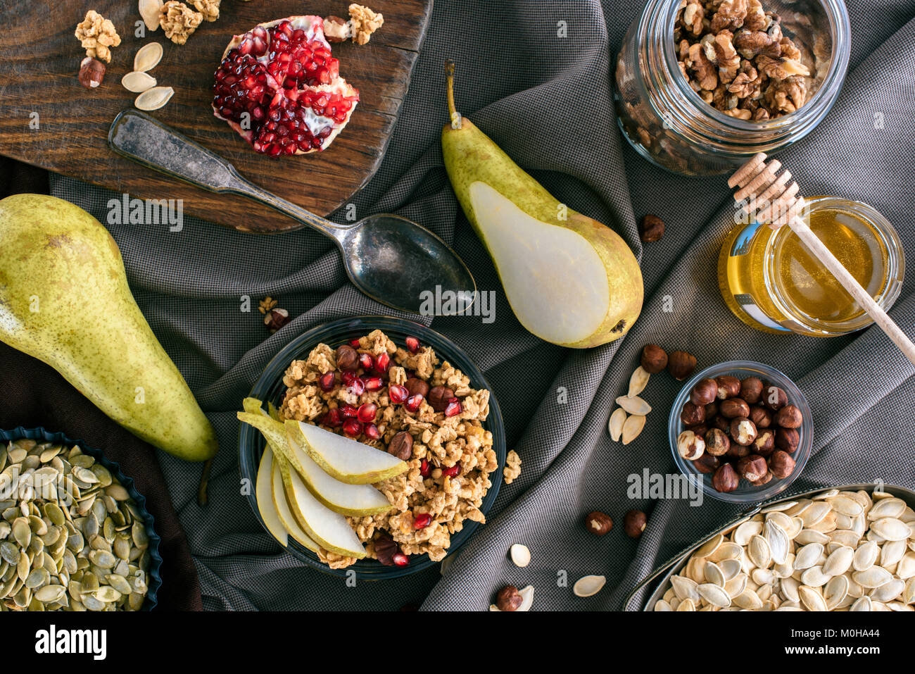 top view of granola ingredients and bowl with granola on table Stock
