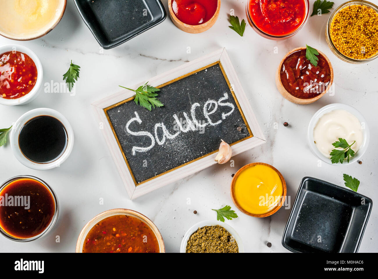 Set of different sauces ketchup, mayonnaise, barbecue, soy, teriyaki, mustard, grain hills