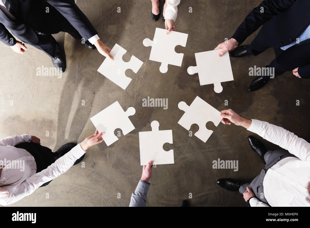 Teamwork of partners. Concept of integration and startup with puzzle pieces Stock Photo