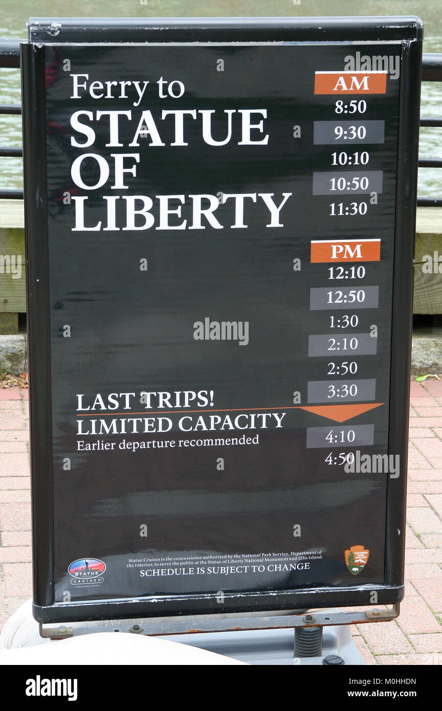 Timetable of Ferries towards the Statue of Liberty on Liberty Island on Ellis Island's harbour, Upper New York Bay, New York City, New York State, USA Stock Photo