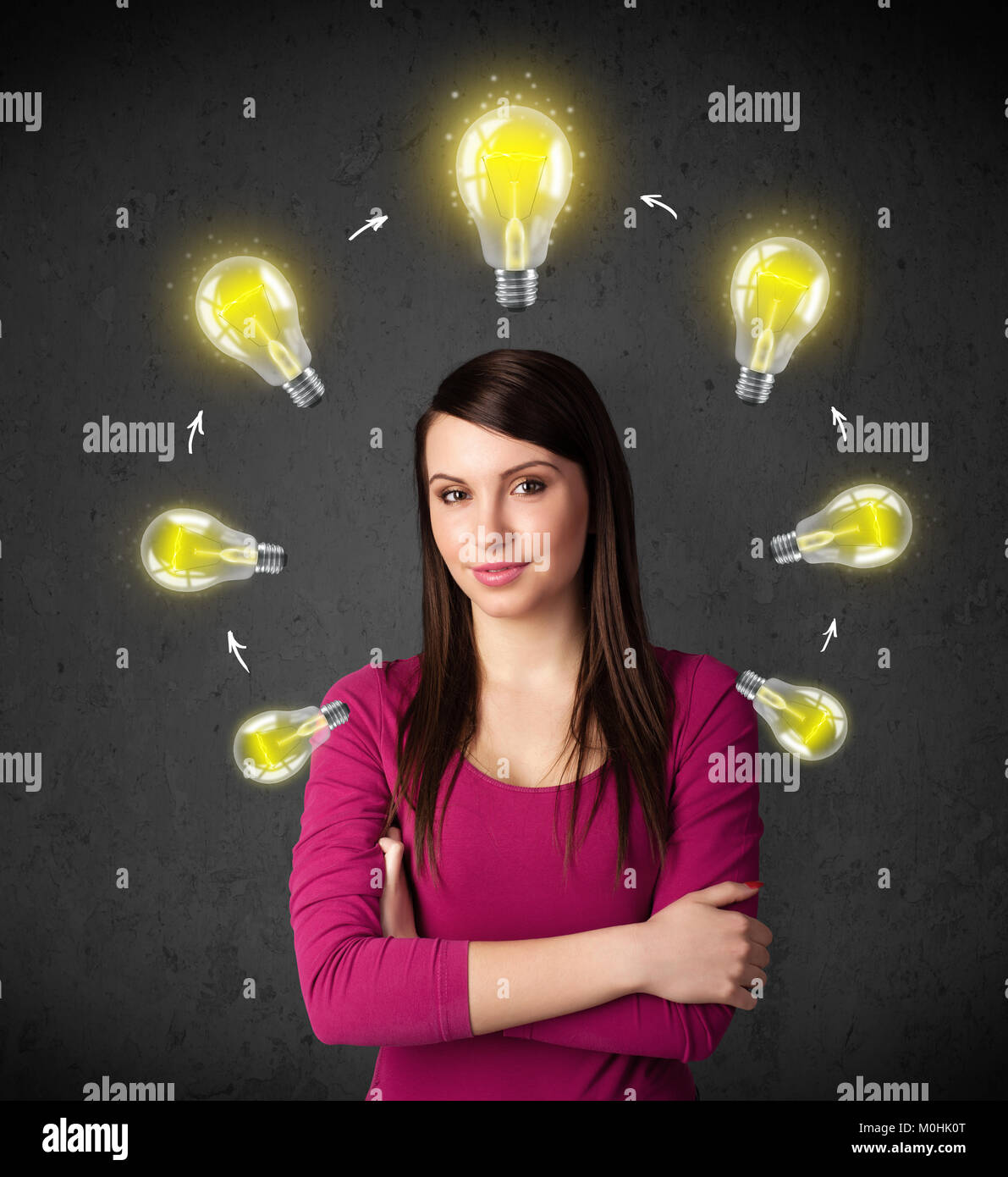 Thoughtful young woman with shining lightbulbs circulating around her ...