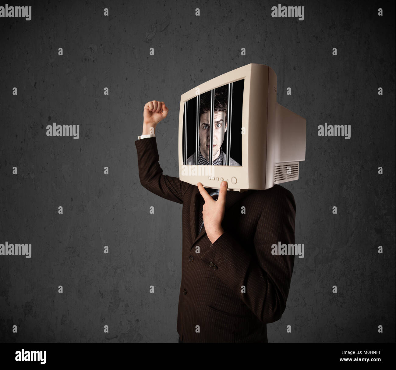 Business man with monitor screen on his head traped into a digital system concept Stock Photo