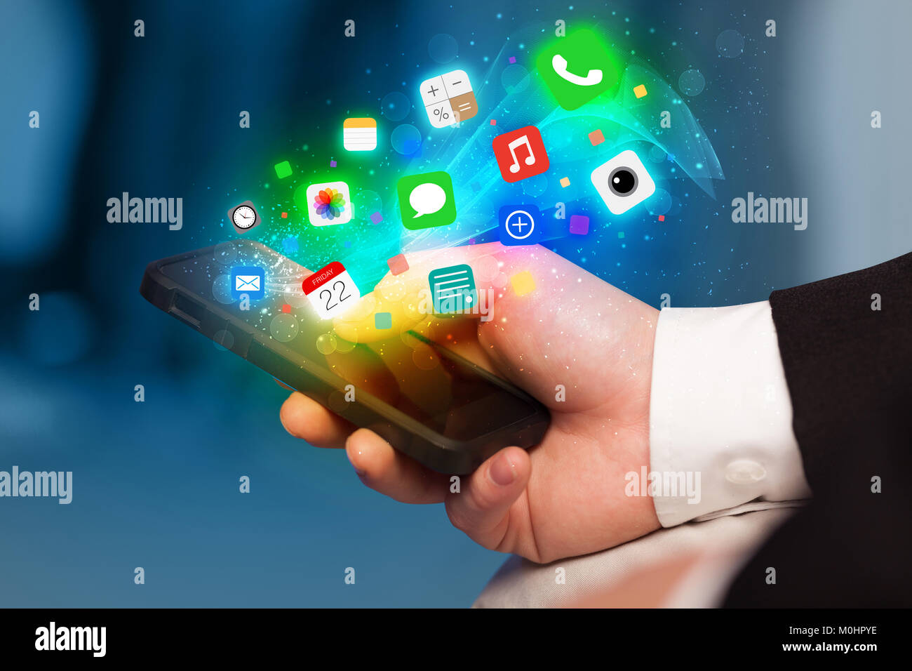 Hand holding smartphone with colorful app icons concept Stock Photo - Alamy
