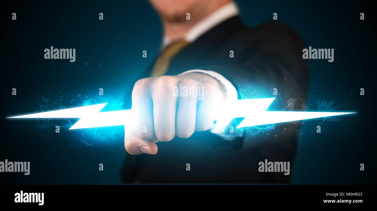 Business man holding glowing lightning bolt in his hands concept Stock ...