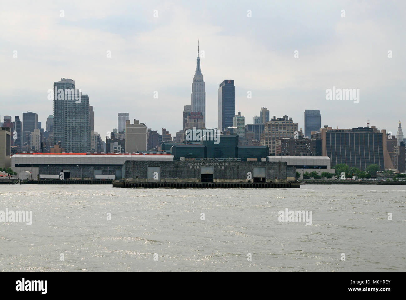 The Department of Marine & Aviation Pier 76 with Midtown Manhattan in the background seen from the Hudson River, New York City, New York State, USA. Stock Photo