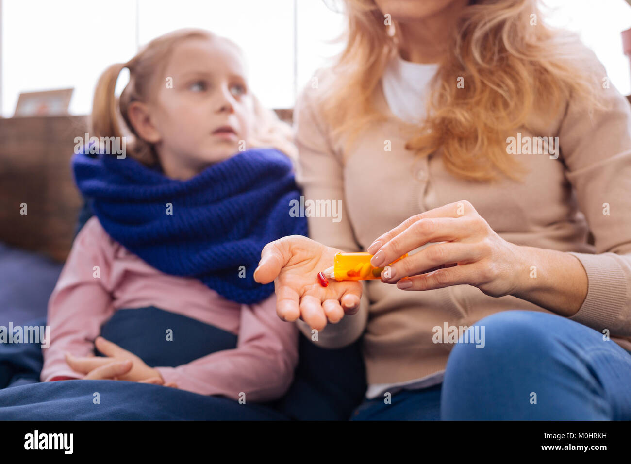 Sad little sick girl taking pills Stock Photo Alamy