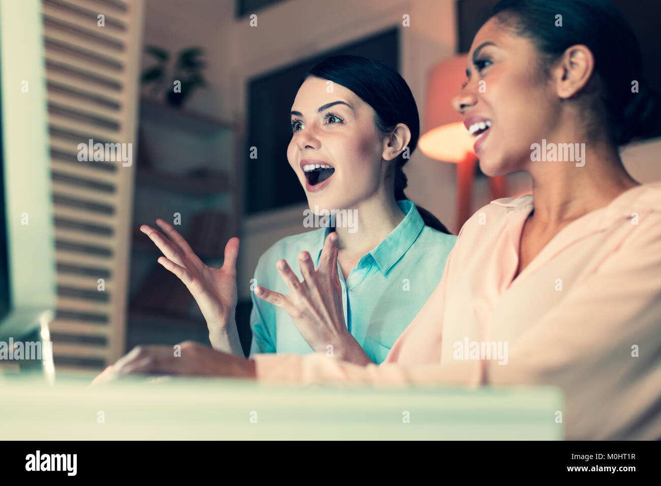 Overjoyed women emotionally reacting to online content Stock Photo