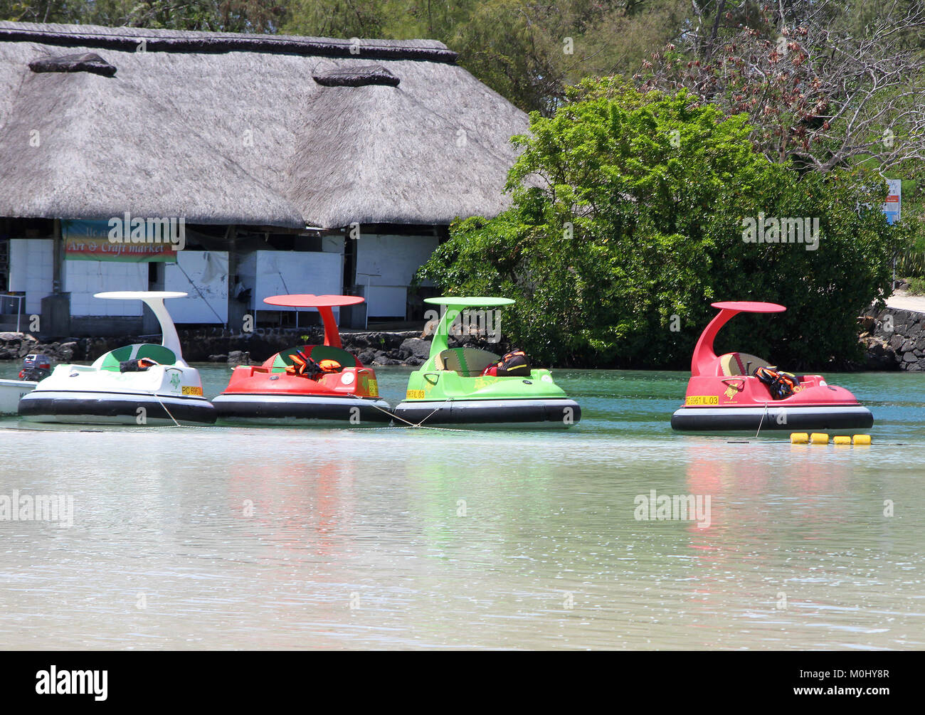 Tied up motorized bumper boats on The Ile Aux Cerfs, a privately owned island near the east coast of The Republic of Mauritius in the Flacq District. Stock Photo