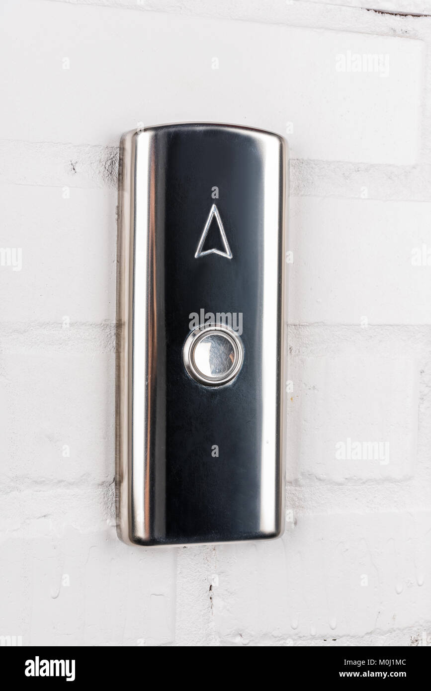 close up view of elevator button up direction on white wall Stock Photo