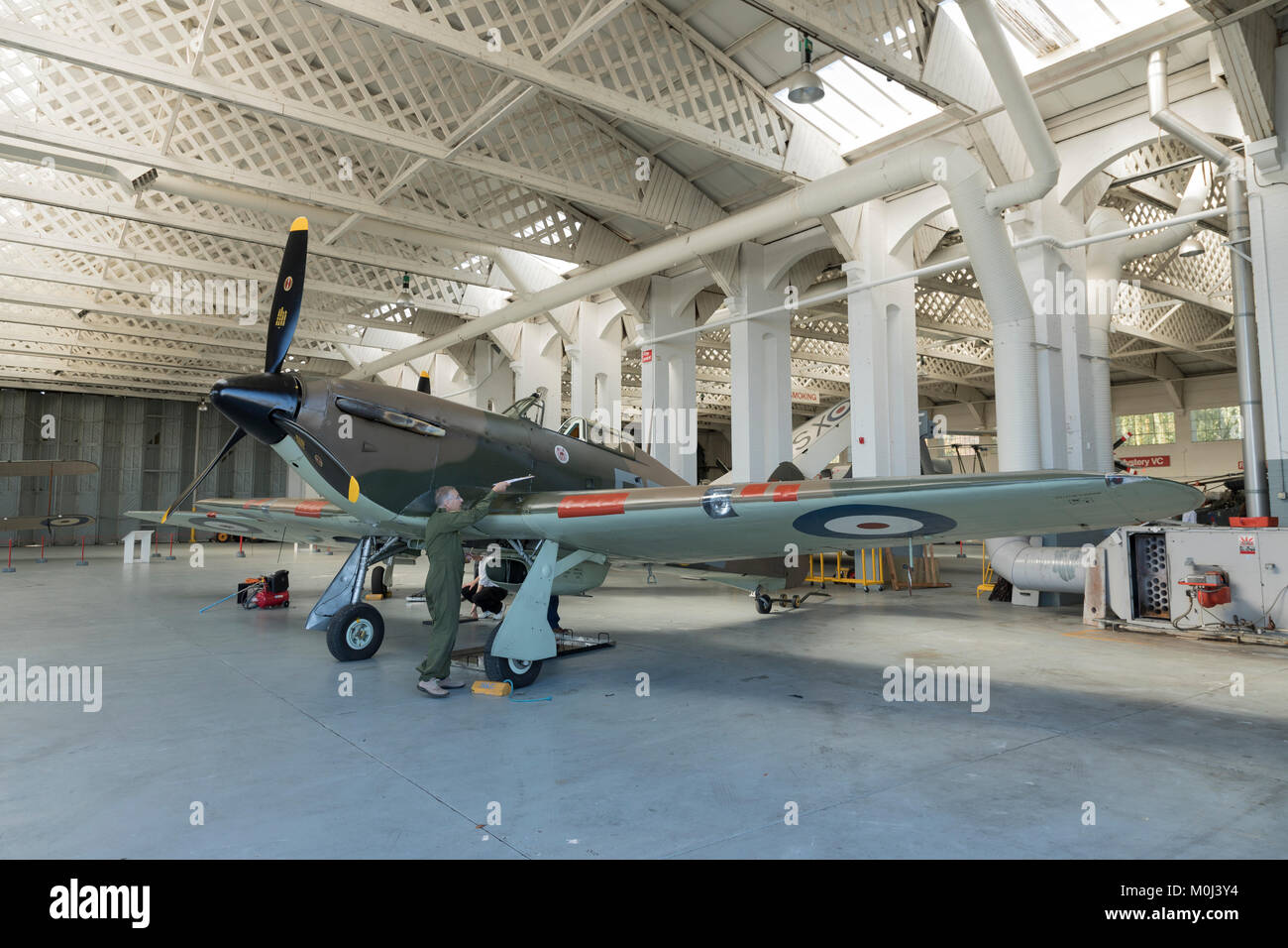 Hawker Hurricane, with a Supermarine Spitfire behind, in an aircraft hangar on September 23rd 2017 at Duxford Cambridgeshire, UK Stock Photo