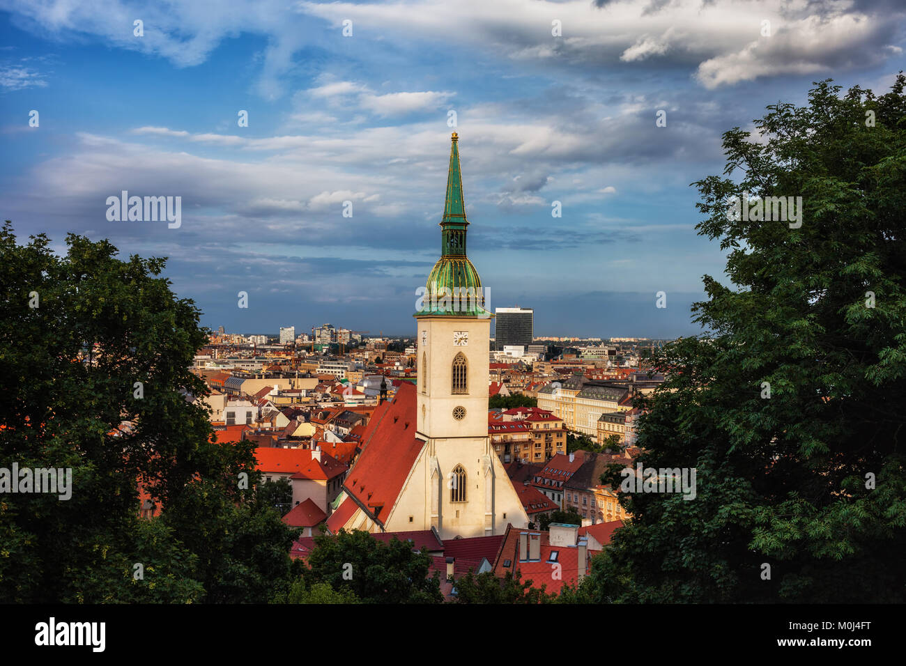 Bratislava at sunset, capital city of Slovakia picturesque cityscape with St Martin's Cathedral framed by the trees. Stock Photo