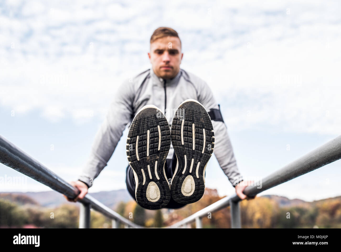 Young man doing exercise in park. Stock Photo
