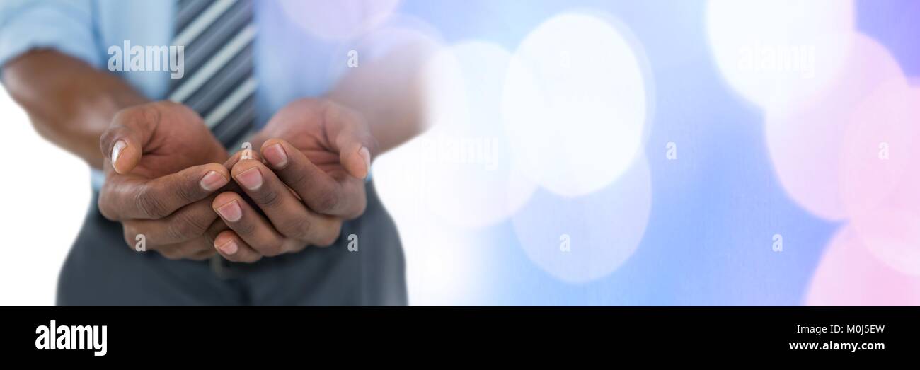 Businessman with pleading cupped hands Stock Photo