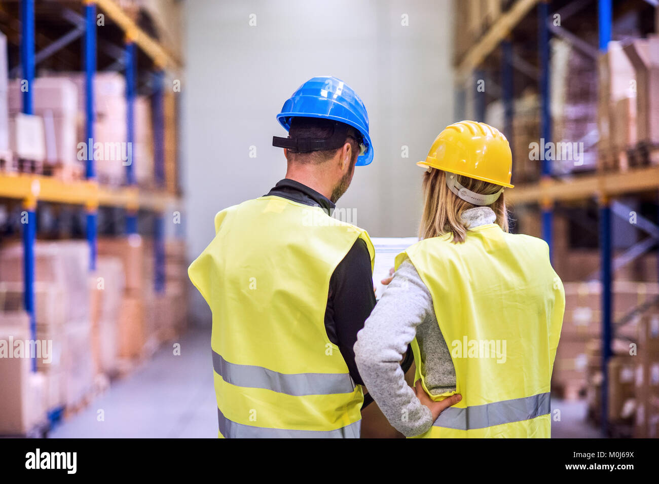 Young warehouse workers working together Stock Photo - Alamy