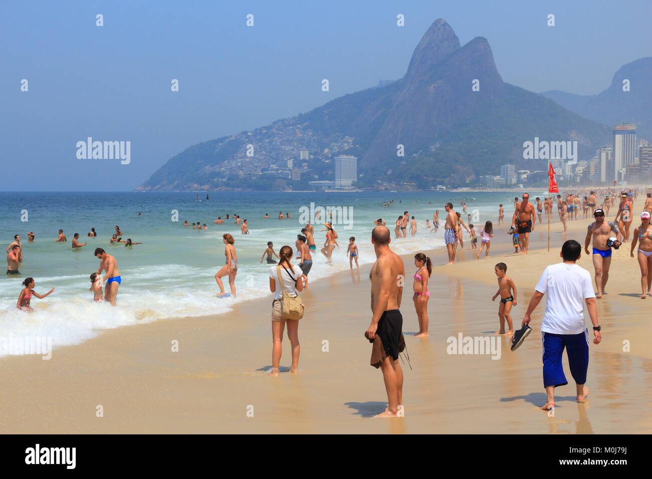 RIO DE JANEIRO, BRAZIL - OCTOBER 19, 2014: People visit Ipanema beach in Rio de Janeiro. In 2013 1.6 million international tourists visited Rio. Stock Photo