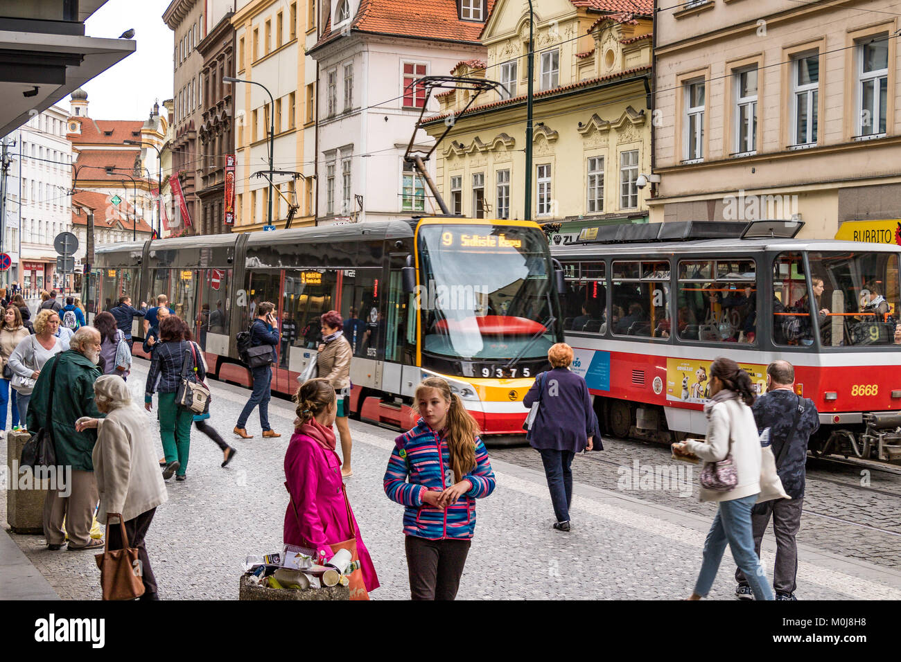 Spálená a busy bustling street in Prague with trams passing through