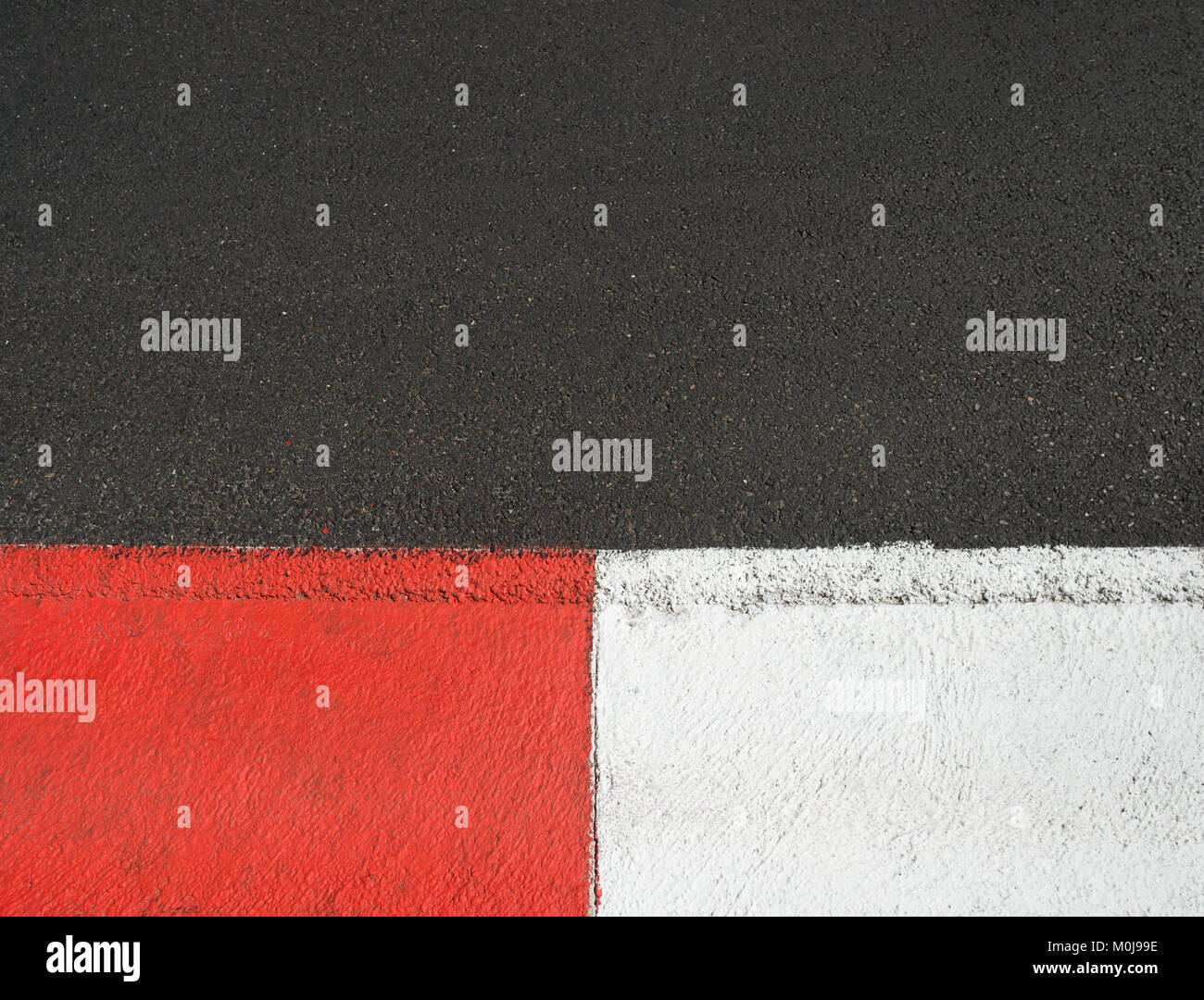 Texture of motor race asphalt and red white curb on Grand Prix street circuit Stock Photo
