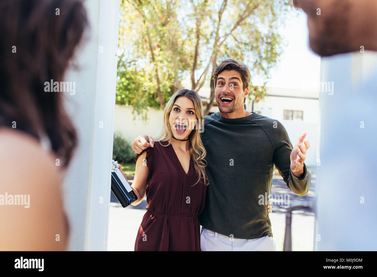 Greeting friends at the door hi-res stock photography and images - Alamy