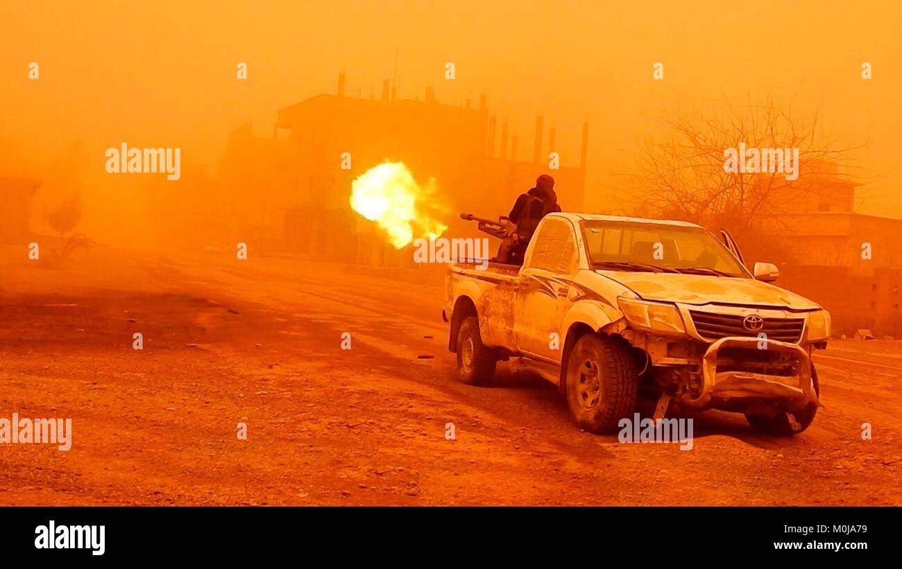 Still image taken from a propaganda video released January 19, 2018 showing Islamic State fighters launching an attack against Syrian government forces during a sandstorm in Al-Bahrah near Deir ez-Zor, Syria. Stock Photo