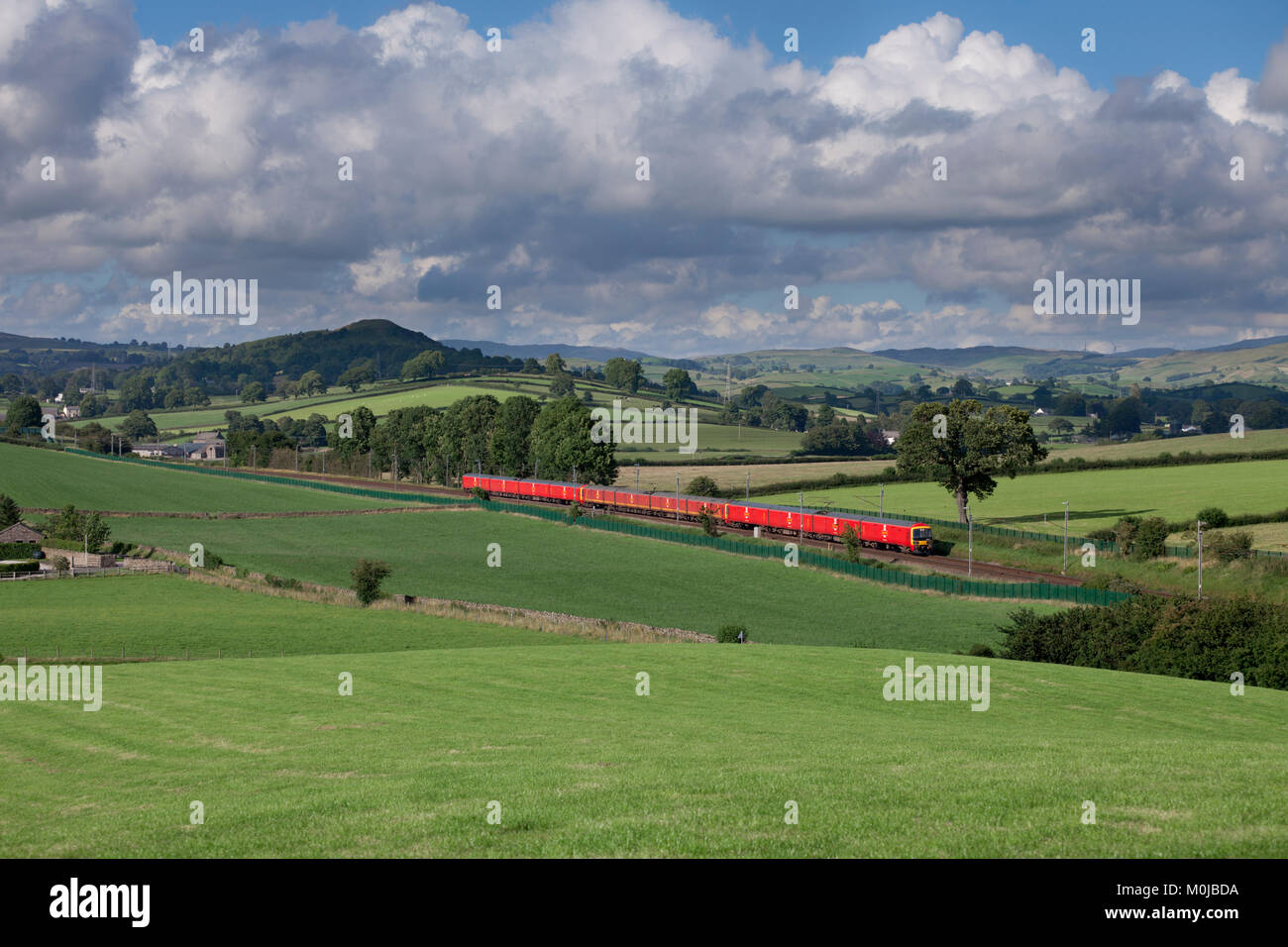 3 Royal Mail class 325 postal trains pass Wellheads, Cumbria on the west coast main line with the 1617 Shieldmuir - Warrington Dallam mail Stock Photo