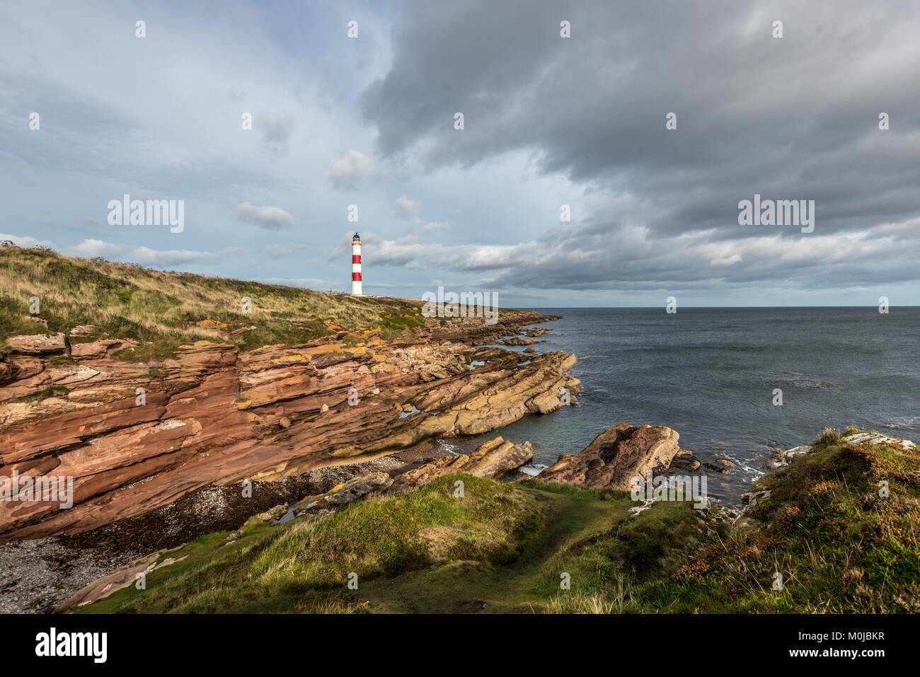 The Tarbat Ness Lighthouse is located at the North West tip of the Tarbat Ness peninsula near the fishing village of Portmahomack in Scotland. Stock Photo