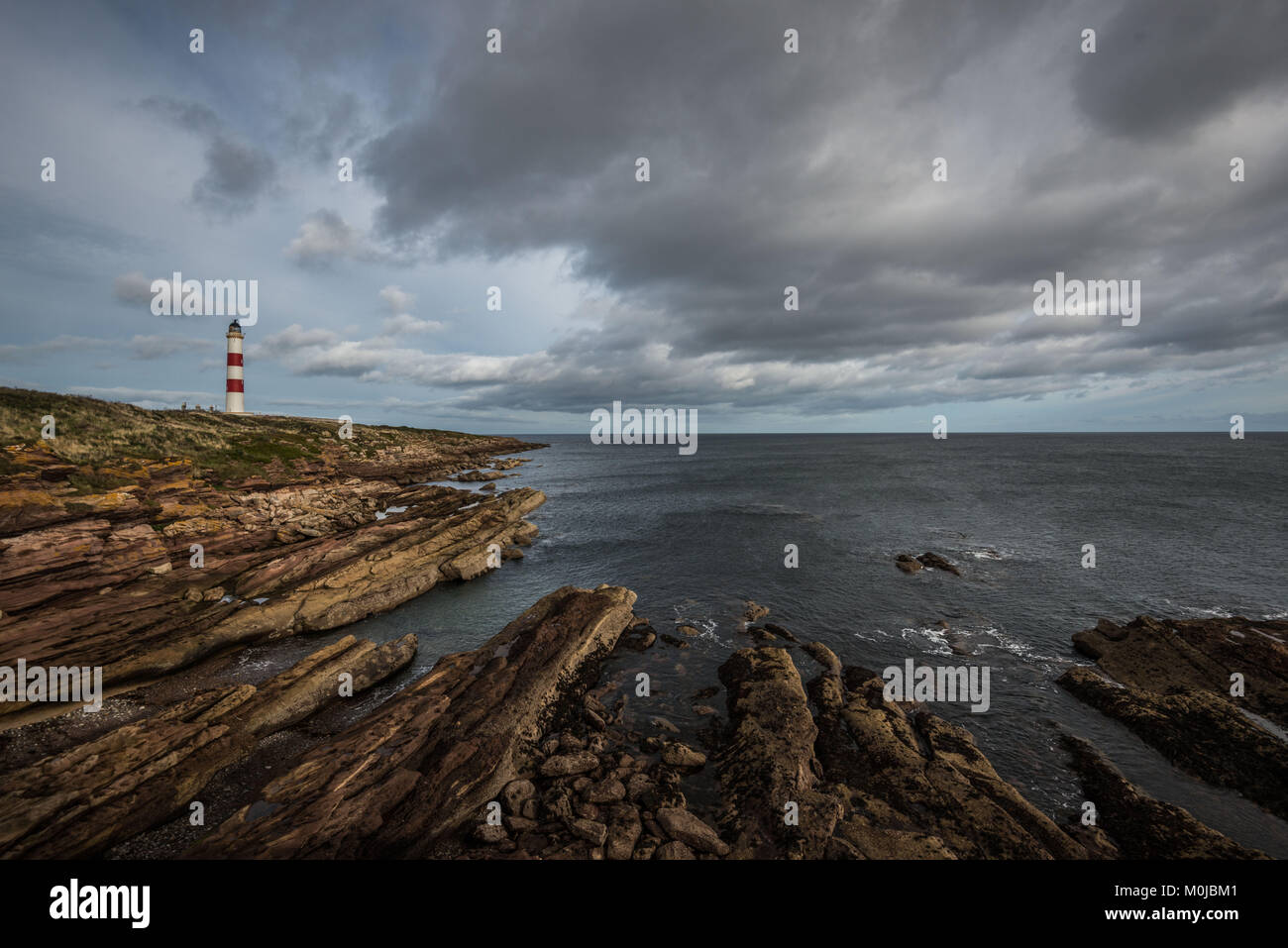 The Tarbat Ness Lighthouse is located at the North West tip of the Tarbat Ness peninsula near the fishing village of Portmahomack in Scotland. Stock Photo