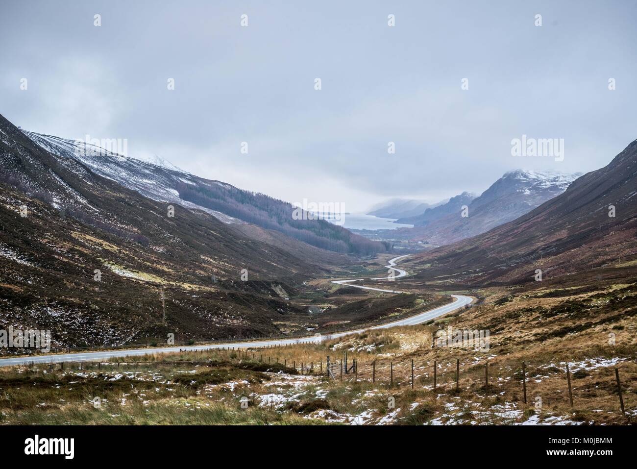 A stunning viewpoint on the A832 to Gairloch, in Glen Docherty, Scotland showing the winding road down to Kinlochewe and the tip of Loch Maree. Stock Photo