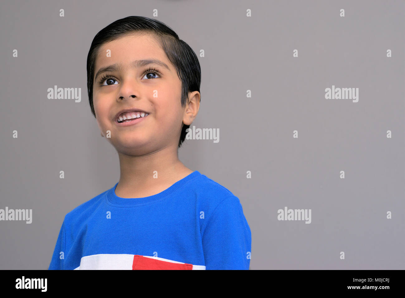 Thinking child imagining. Concept of imagining kid. Thinking kid looking up. Stock Photo