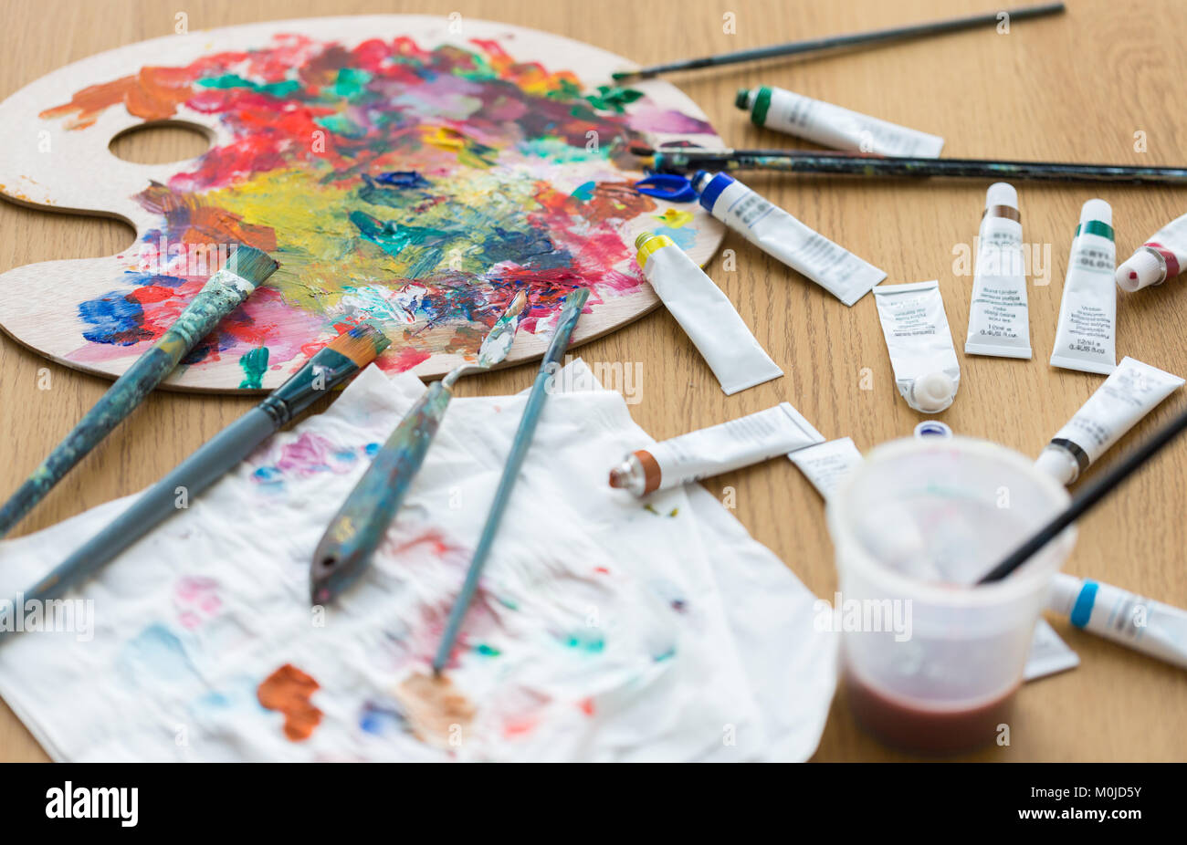 palette, brushes and paint tubes on table Stock Photo Alamy