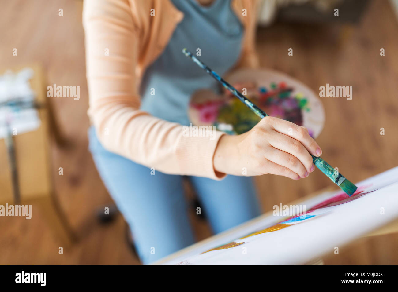 artist with palette and brush painting at studio Stock Photo - Alamy