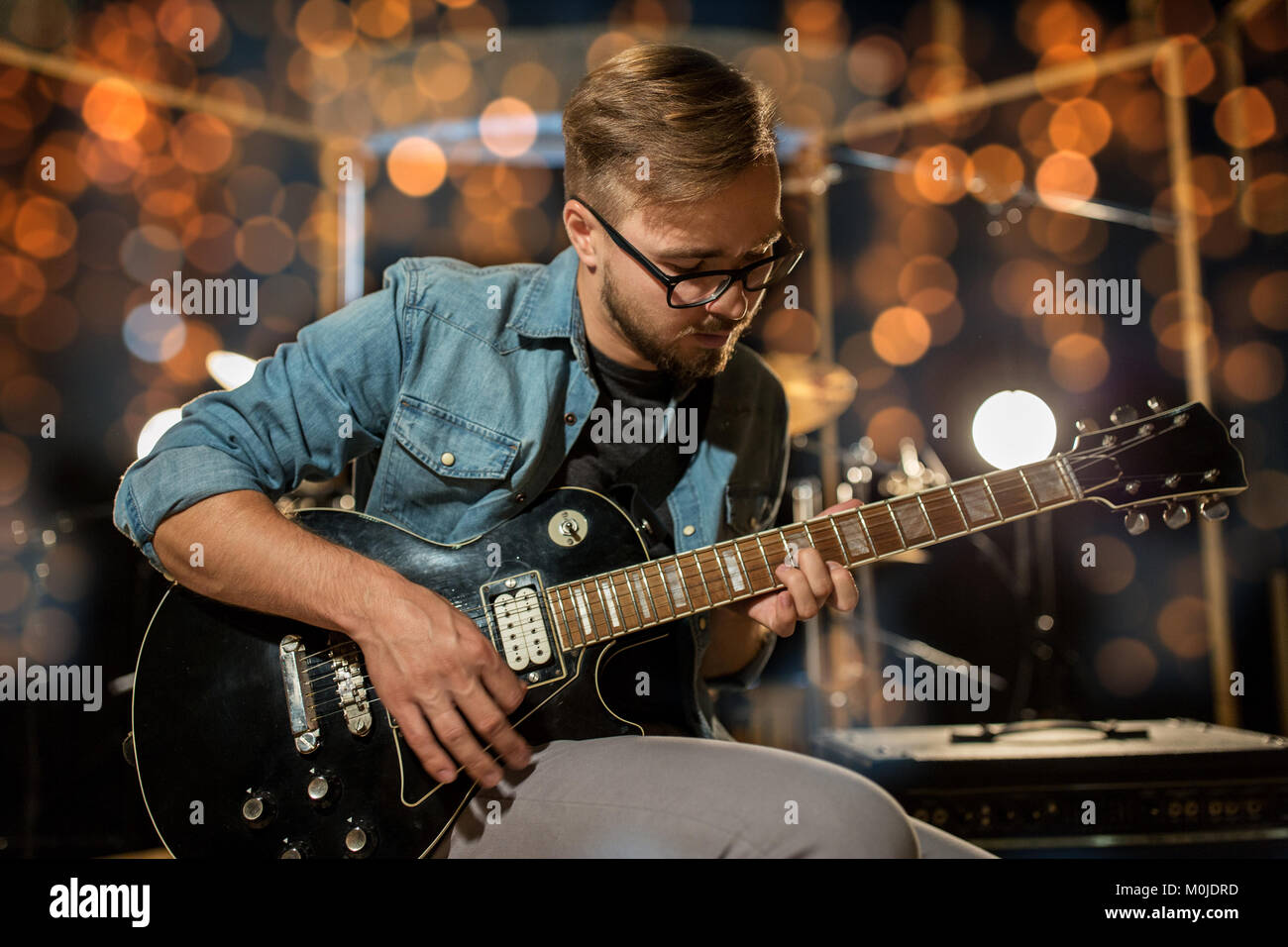 Over Light Photo Example musician playing guitar at studio over lights Stock Photo - Alamy