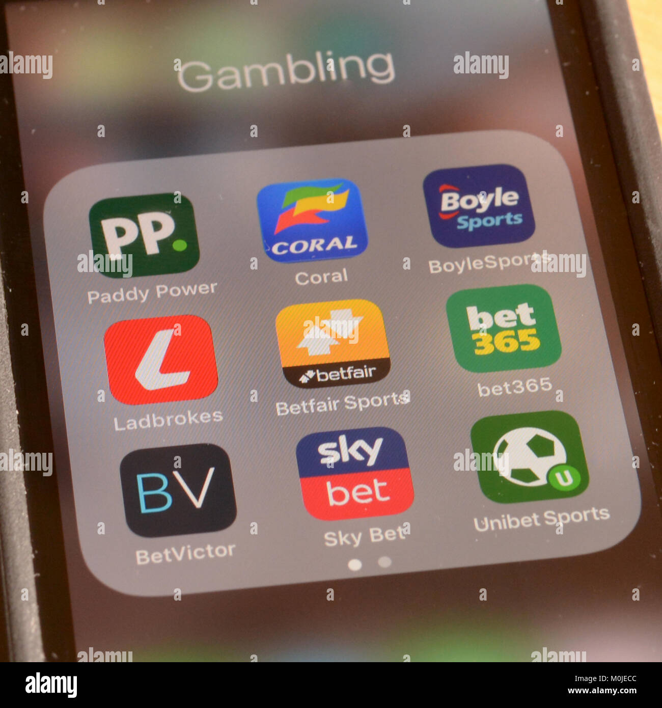 Smart phone screen showing a range of bookmakers gambling apps or  applications - it is incredibly easy to bet quickly anywhere in the world Stock Photo