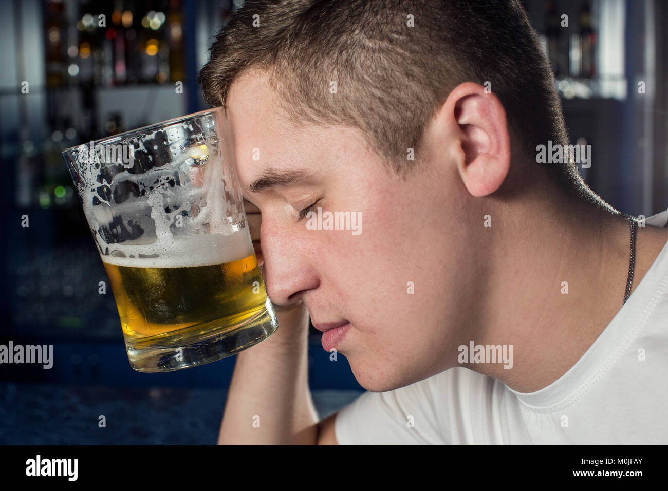 Alcohol, problems. Young alcoholic with beer Stock Photo
