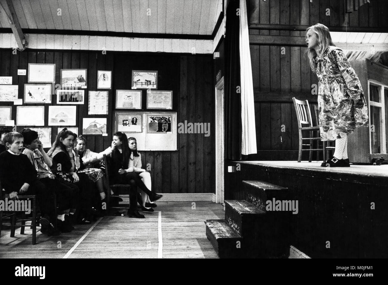 Young girl giving recitation on stage at village hall small eisteddfod Llangynidr Powys Wales UK Stock Photo