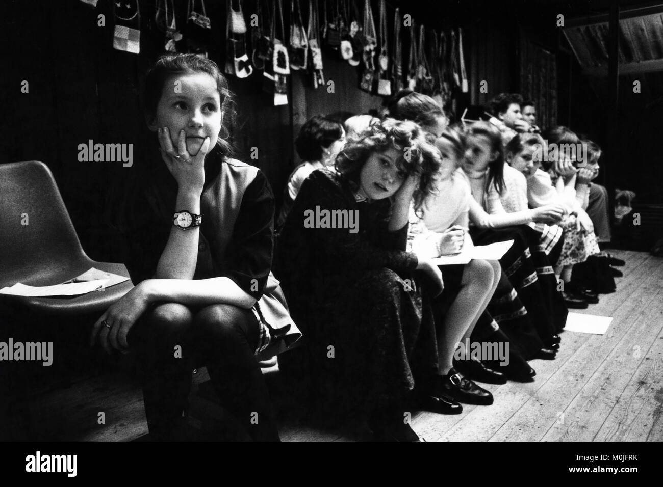 Young girls wait to perform on stage at village hall small eisteddfod Llangynidr Powys Wales UK Stock Photo