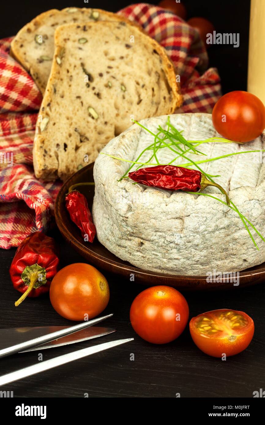 Domestic mature mold cheese. Dairy product. Aromatic cheese with mold Stock Photo