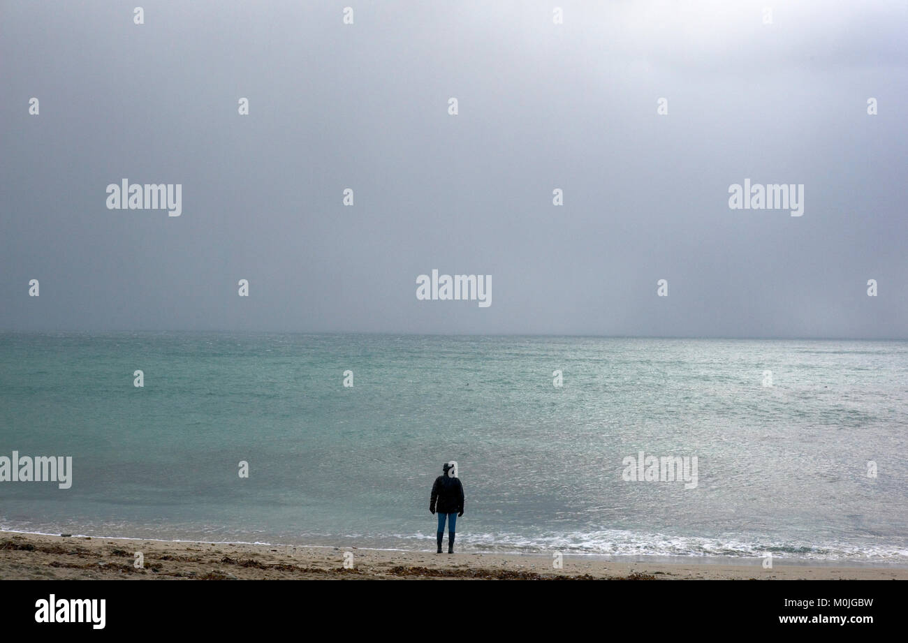 A tourist walks along Towan Beach, near Portscatho on the Roseland Peninsula, in Cornwall, Britain December 29, 2017 Stock Photo