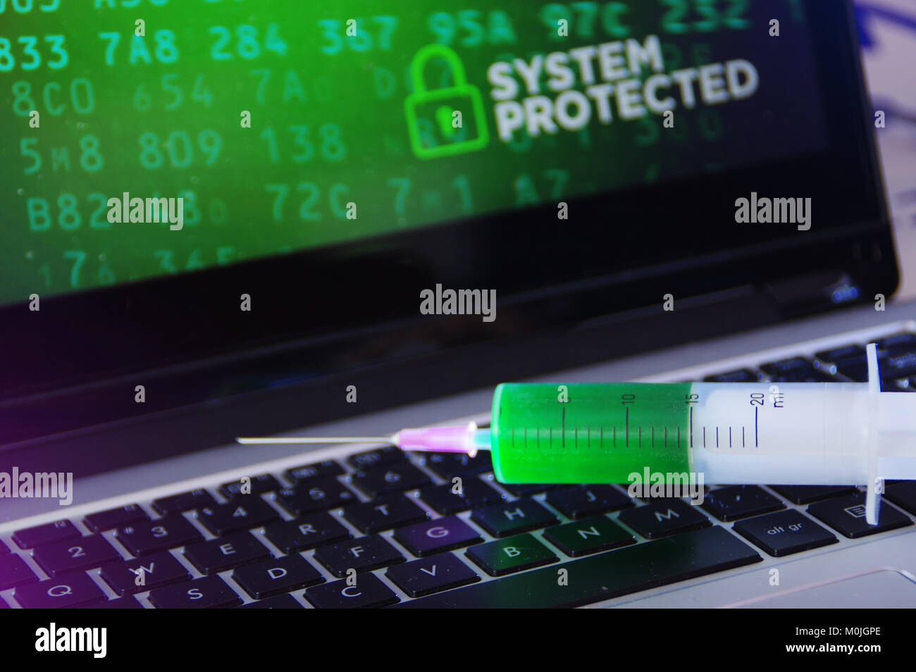 Concept of antivirus, system protection and cybersecurity. Vaccination in the syringe on computer keyboard. Stock Photo