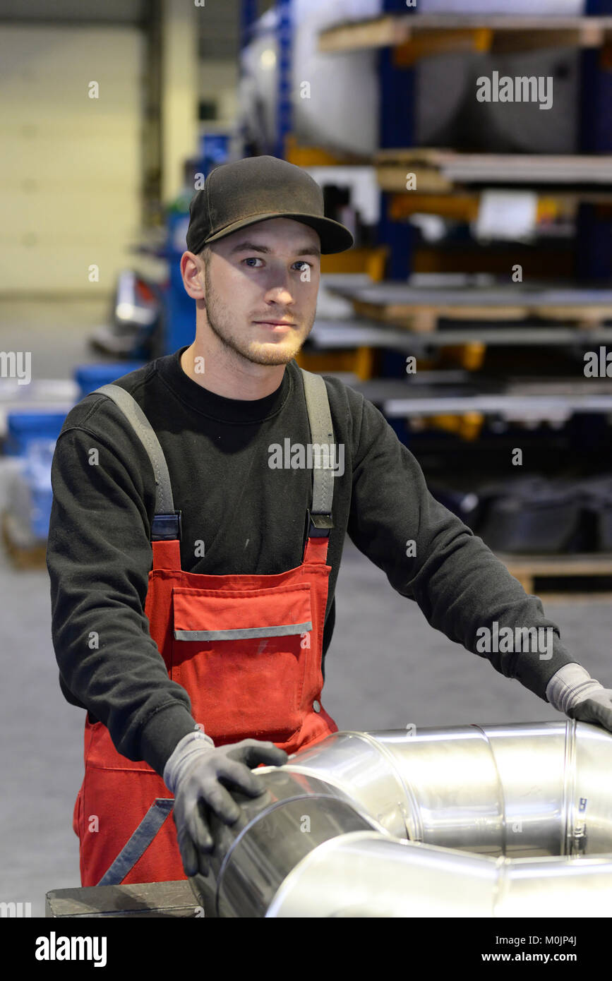 portrait of young apprentices in a metalworking company Stock Photo