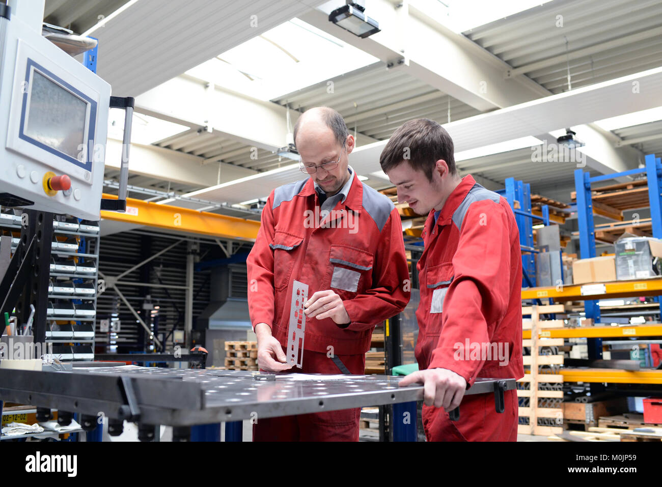 apprentice and trainer in a metalworking company - apprenticeship in the trade Stock Photo