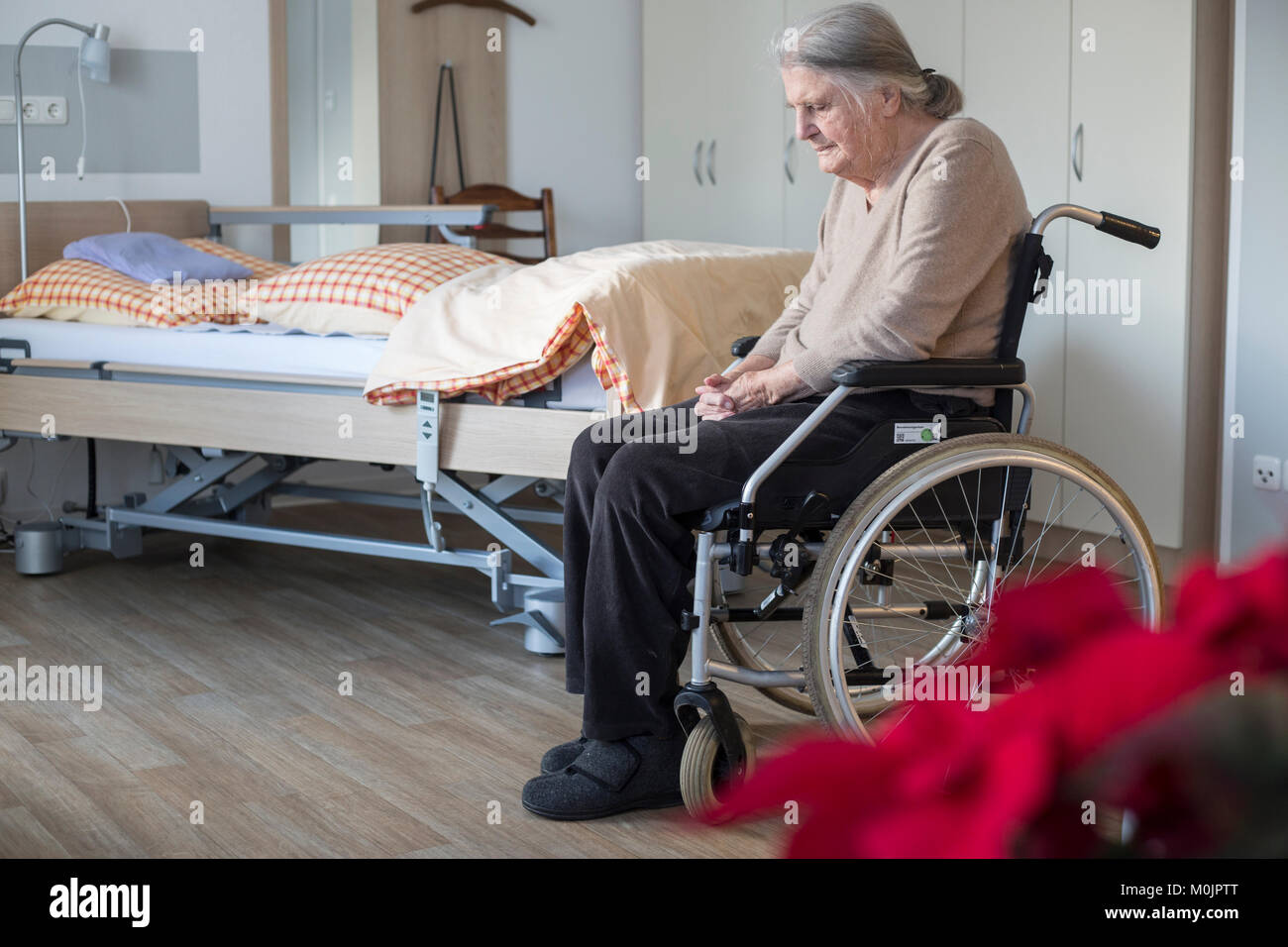 Demented Senior in a wheelchair alone in her room in a nursing home, Cologne, North Rhine-Westphalia, Germany Stock Photo