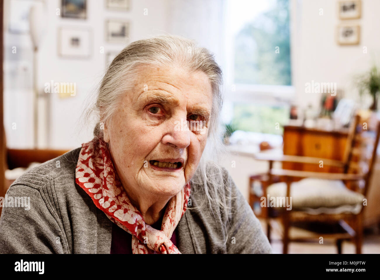 Demented Senior in a wheelchair alone in her room in a nursing home, Cologne, North Rhine-Westphalia, Germany Stock Photo
